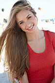 A young blonde woman wearing a red dress