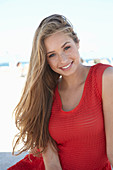 A young blonde woman wearing a red dress