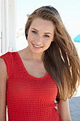 A young blonde woman wearing a red dress