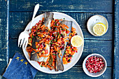 Trout baked with root veggies, dried fruits and almonds