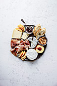 Cheese and ham plate with parmesan, camamber, goat cheese, ham and snacks