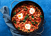 Shakshuka with silverbeet in a pan
