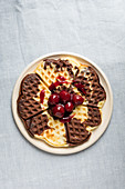 Black and white waffles with cherry compote