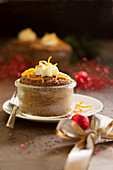 Chestnut muffin baked in a glass with orange cream and zest (Christmas)