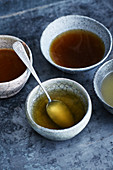 Various basic broths in earthenware bowls