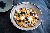 Porridge with blueberries, yogurt, peanut butter and maple syrup