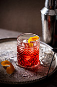 Negroni cocktail (vermouth, gin and campari) with orange zest