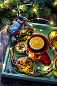 Christmas Tea with orange and biscuits with chocolate on a tray