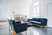Blue sofa set in white living room in period apartment