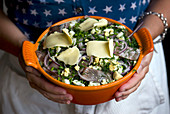 Soused herring with egg, red onions, dill and cheese in a baking dish, uncooked (Scandinavia)