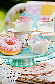 Pastries with colourful decorations on cake stand made from stacked crockery