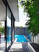 Corner swimming pool in the garden of a modern house