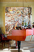 Red grand piano and abstract painting