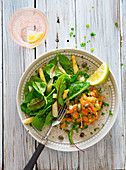 Salmon tartare and a mixed leaf salad with asparagus
