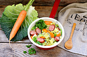 Savoy cabbage stew with carrots and smoked sausage