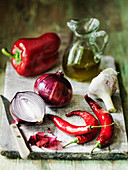 Selection of Spanish food ingredients - olive oil garlic red chillies red onions and red pepper