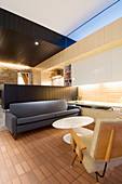 Designer furniture in interior with open-plan kitchen