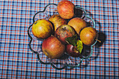 Apples in a glass bowl on a checkered tablecloth