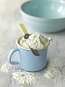 Flour measured for baking in blue jug