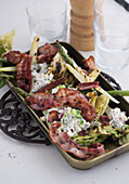 Grilled lettuce with bacon, asparagus and blue cheese