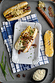 Hot dogs made with German sausages, bacon, coleslaw and caramelised onions