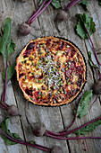 Beetroot quiche with feta cheese and beansprouts (seen from above)