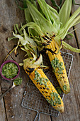Grilled corn cobs with a lime and coriander pesto