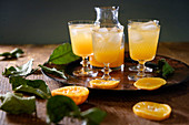 An orange cocktail over ice