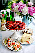 A buffet with crayfish, cheese and salmon rolls