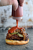 A vegetarian burger with aubergines and ketchup