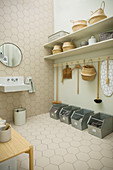 Tidy utility room in natural shades with honeycomb tiles