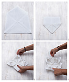 A fabric napkin being folded into a flower