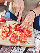 Tomatoes being sliced and deseeded