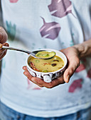 A person eating oriental coconut soup