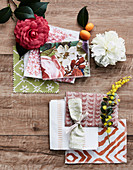 Fabric samples, flowers and kumquats on a wooden background