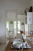 Open doorway and serving hatch between kitchen and dining room