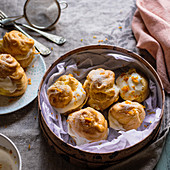 Cream puffs choux à la crème with orange custard and Italian meringue