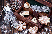 Christmas gingerbread cookies and chocolate candies in wooden gift box