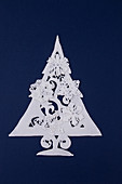 Christmas tree made of sugar icing on deep blue background