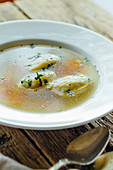 Traditional chicken soup with carrot and dumplings