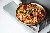 Spaghetti with meatballs, tomato sauce, parsley and cheese