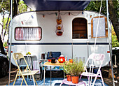 A camping table set for tea outside a caravan (Italy)