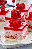 A slice of raspberry cheesecake with raspberry mousse