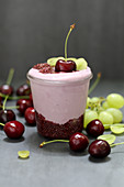 Yoghurt and chia dessert with cherries and grapes