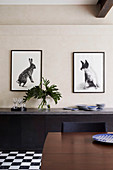 Two animal pictures above the sideboard in the dining room