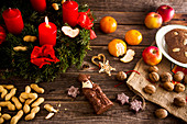 An Advent wreath, a chocolate Father Christmas, nuts and gingerbread