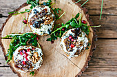 Bruschette with blue cheese, dry figgs and pomegranate