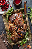 Whole baked beef with cranberry sauce and garlic above