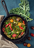 Scrambled eggs with kale and tomatoes