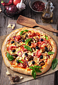 Pizza Veronese with tomatoes, mozzarella, mushrooms and prosciutto